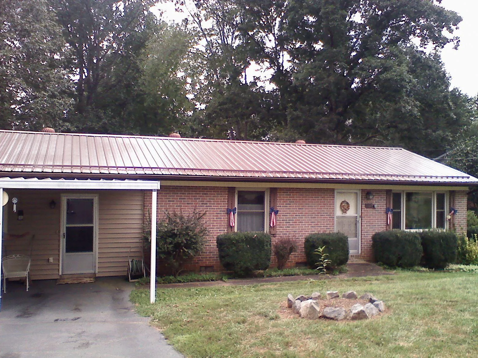 Bronze metal roof and carport on a brick ranch home — Roof Repair work by our crew in Prior Lake